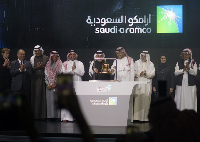 Saudi Arabia's state-owned oil company Saudi Armco and stock market officials celebrate during the official ceremony marking the debut of Aramco's initial public offering (IPO) on the Riyadh's stock market, in Riyadh, Saudi Arabia, Wednesday, Dec. 11, 2019. [Photo: AP/Amr Nabil]