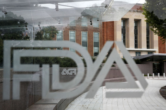 This Aug. 2, 2018, file photo shows the U.S. Food and Drug Administration building behind FDA logos at a bus stop on the agency's campus in Silver Spring, Md. [Photo: AP]