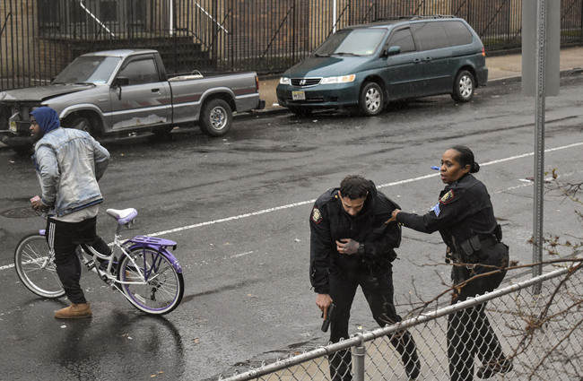 In this Dec. 10, 2019 photo, Jersey City police Sgt. Marjorie Jordan, right, helps fellow officer Raymond Sanchez to safety after he was shot during a gunfight that left multiple dead in Jersey City, N.J. [Photo: AP/Justin Moreau]