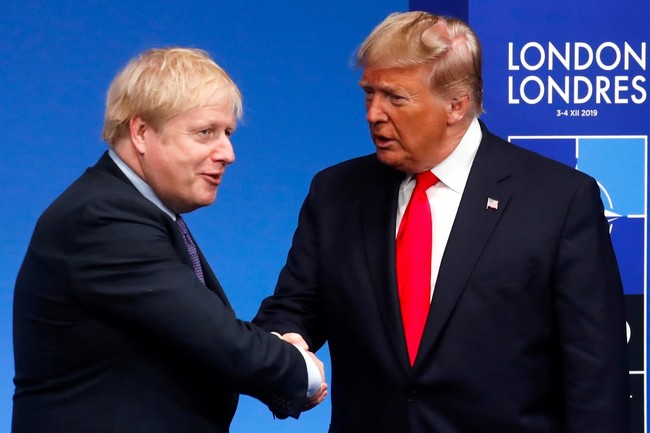 Britain's Prime Minister Boris Johnson (L) shakes hands as he greets US President Donald Trump upon his arrival for the NATO summit at the Grove hotel in Watford, northeast of London on December 4, 2019. [Photo: AFP]