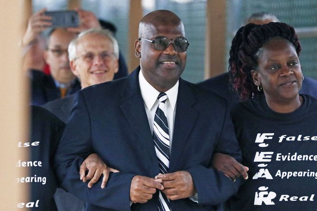 Curtis Flowers flanked by sister Priscilla Ward, right, exits the Winston Choctaw Regional Correctional Facility in Louisville, Miss., Monday, Dec. 16, 2019. [Photo: AP]