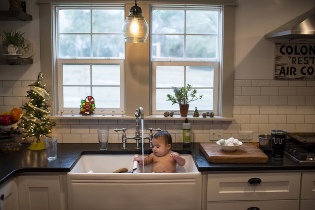 Mayor Charlie McMillan, the youngest mayor in America in the unincorporated Grimes County community of Whitehall, gets washed off in the sink after getting some of his breakfast on himself in Whitehall, Texas on December 20, 2019. [Photo: AFP]