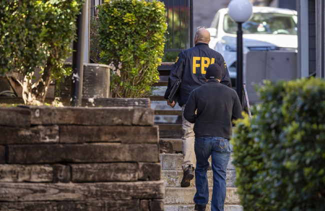 In this Dec. 18, 2019 photo, FBI agents canvas the neighborhood searching for information on Heidi Broussard, a missing Austin, Texas, woman and her infant daughter in South Austin, Texas. [Photo: AP]