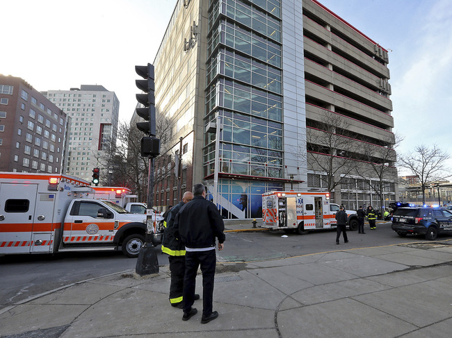 Emergency personnel at the scene of an incident at the Renaissance Park Garage where an adult and 2 children fell from the garage and were found dead on a sidewalk near the Boston parking garage on Christmas Day, Wednesday, Dec. 25, 2019. [Photo: AP]