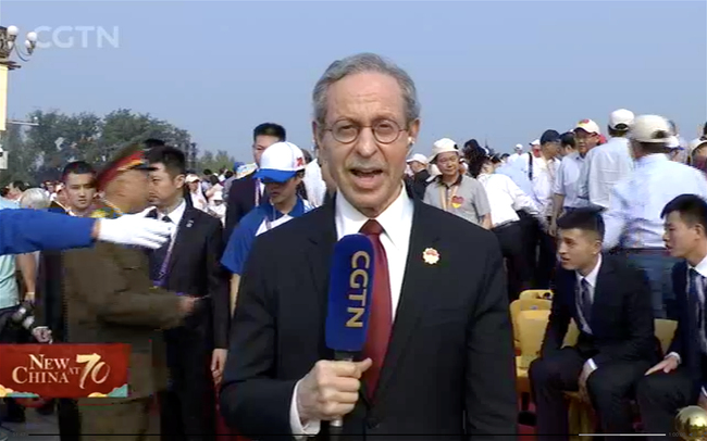 Robert Lawrence Kuhn does a live coverage for CGTN on the grand parade to celebrate the 70th anniversary of the founding of the People's Republic of China at the Tiananmen Square in Beijing on Oct 1st, 2019. [Photo: CGTN]