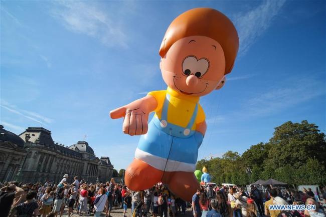 Des gens assistent à la Balloon's Day Parade de la Fête de la BD de Bruxelles 2019 à Bruxelles, en Belgique, le 15 septembre 2019. (Xinhua/Zhang Cheng)