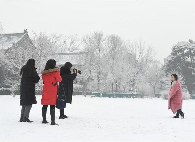 Des piétons marchent sous la neige à Beijing, capitale chinoise, le 16 décembre 2019. De la neige est tombée sur Beijing lundi. (Photo : Ju Huanzong)
