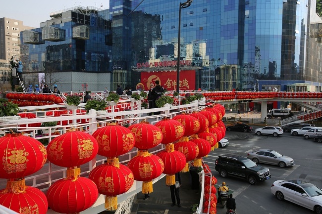 Ένας δρόμος στο Σι’αν, στην επαρχία Σαανσί της βορειοδυτικής Κίνας, είναι διακοσμημένος με κόκκινα φανάρια (灯笼 dēnglong) και κινεζικούς κόμπους (中国 结 zhōngguójié) στις 9 Φεβρουαρίου 2021. [Φωτογραφία: VCG]