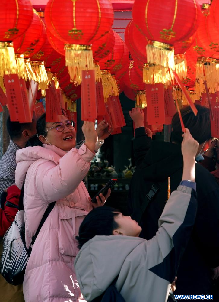 Άνθρωποι συμμετέχουν σε μια εκδήλωση φαναριών με αινίγματα σε ένα χωριό ειδικά διαμορφωμένο από ταινίες, στην περιοχή Τζονγκμού της πόλης Τζενγκτζόου, στην επαρχία Χενάν, στην κεντρική Κίνα, στις 16 Φεβρουαρίου 2024. (Xinhua/Li An)